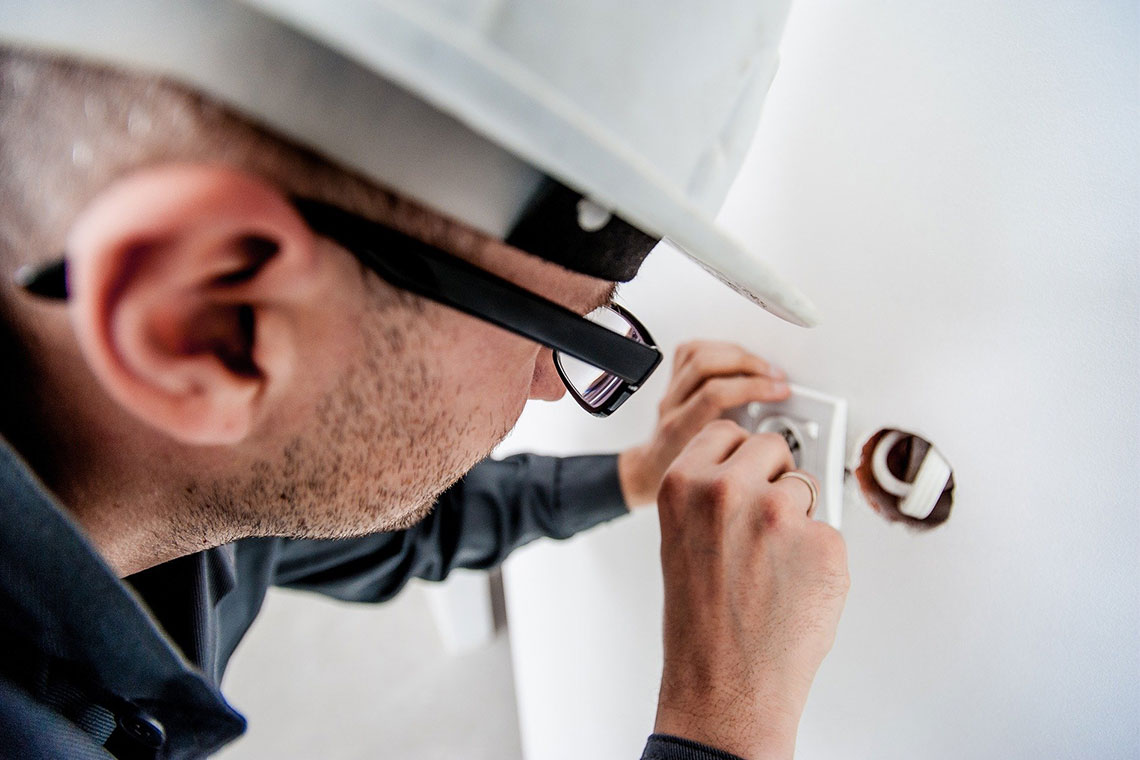 An Electrician Is Repairing Electrical Installation In An Apartment
